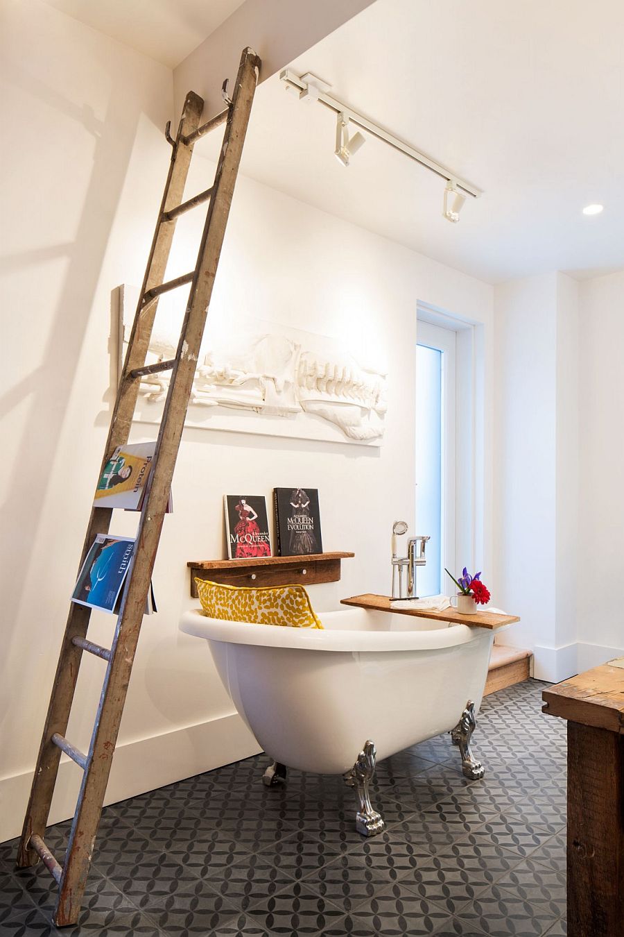 Salvaged wooden shelf, old ladder and vintage bathtub fashion an opulent and distinct bathroom