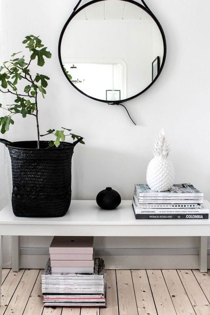 Simple and minimal Scandinavian style entryway with a round mirror