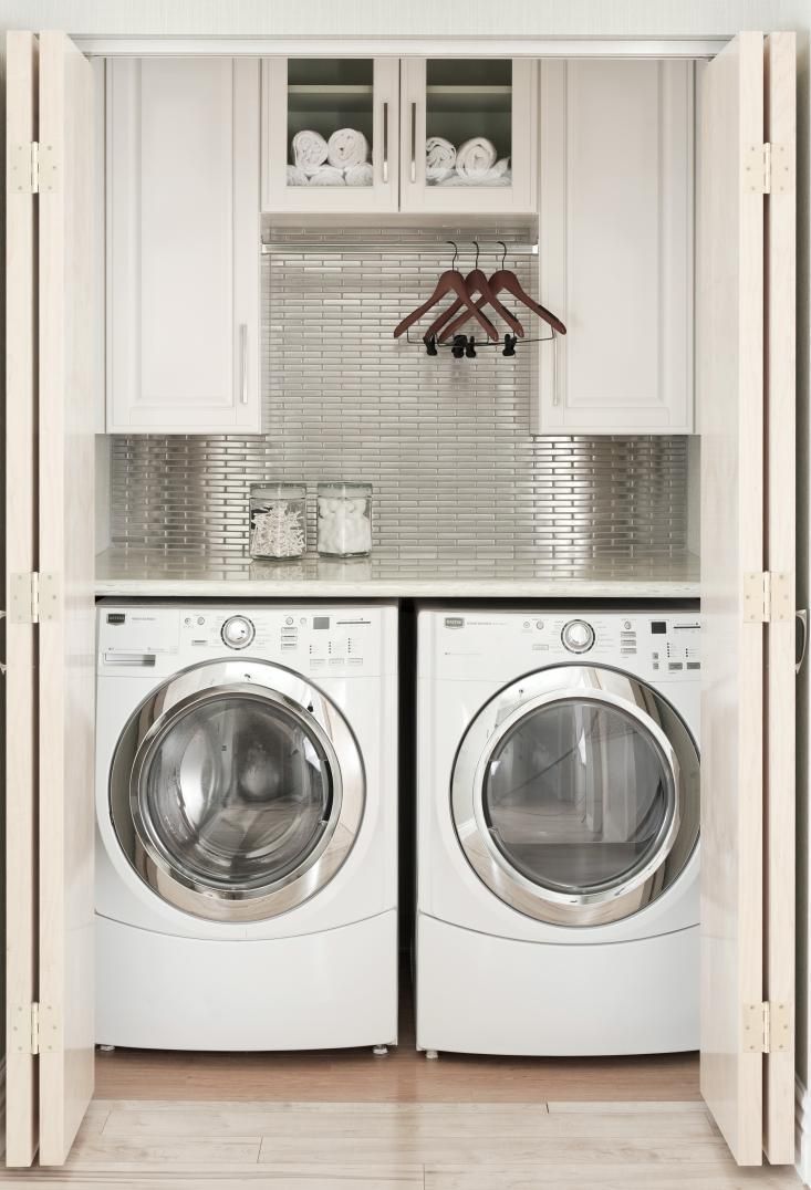 Small laundry nook concealed in large closet