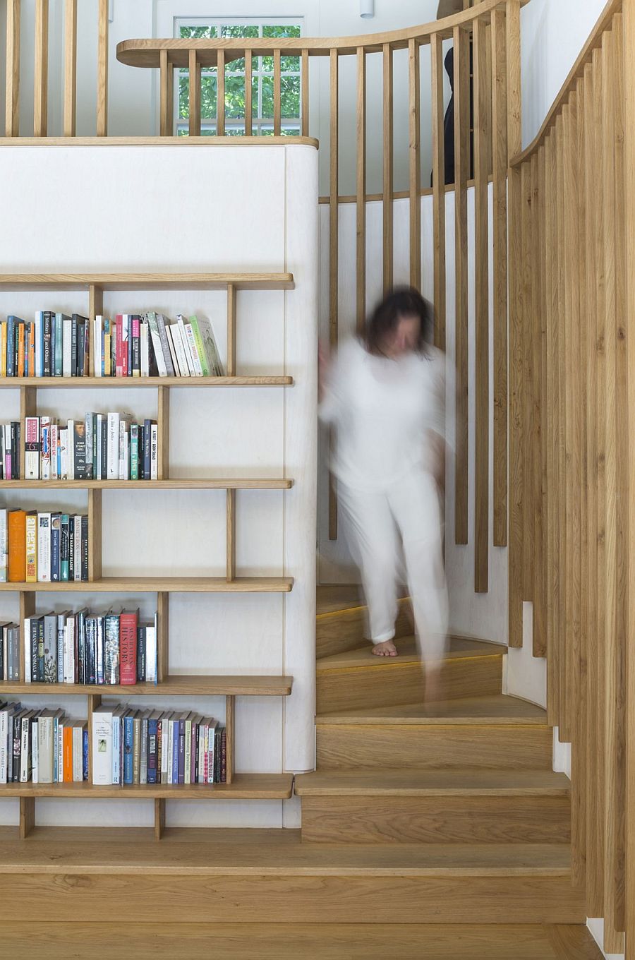 Spiral wooden staircase connects the revamped living area with the top level