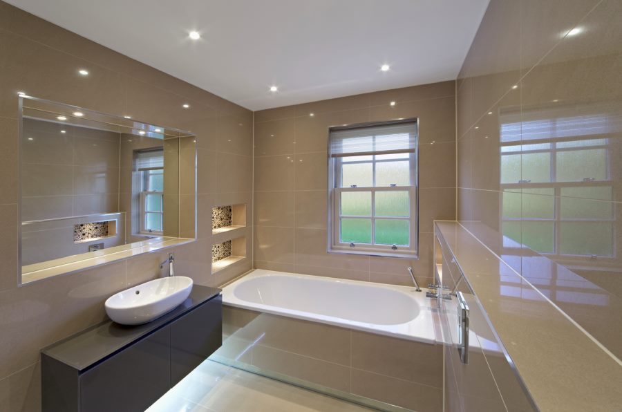 Spotlights reflect in the tile of a modern bathroom