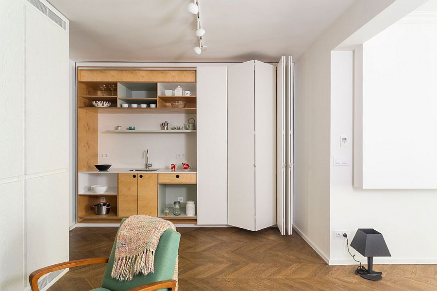 Stackable, folding white doors hide the kitchen when not in use