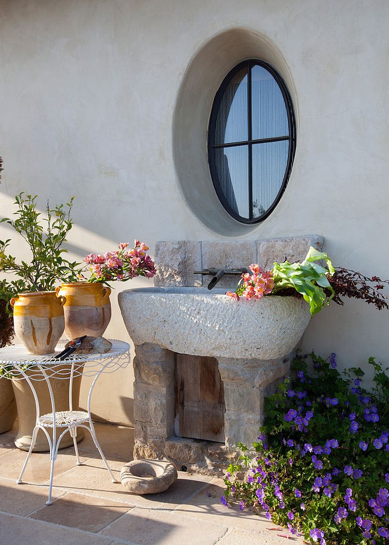 Stone sink in the patio adds to the Mediterranean style of the exterior