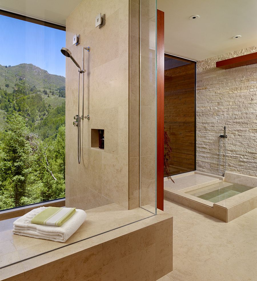 Stone wall brings a rougher texture to the refined contemporary bathroom [Design: C Wright Design]