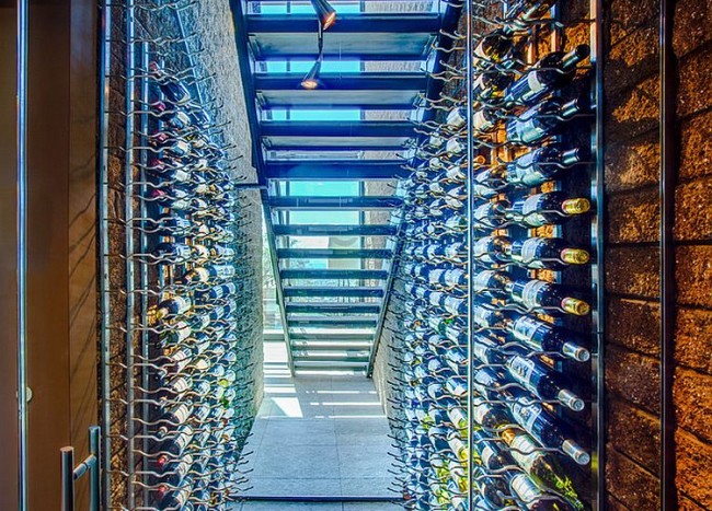 20 Eye Catching Under Stairs Wine Storage Ideas Decoist   Stunning Wine Cellar Under The Staircase With Limestone Floor 650x467 