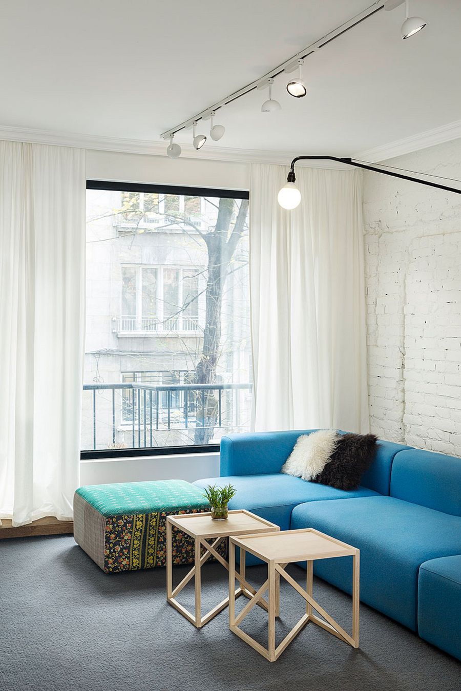 Twin coffee tables create a visual link between the living space and dining area