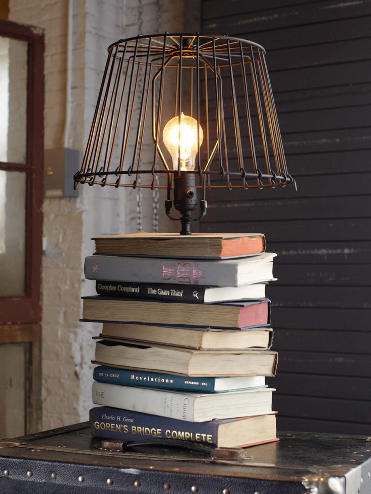 Upcycled industrial lamp with books for its base