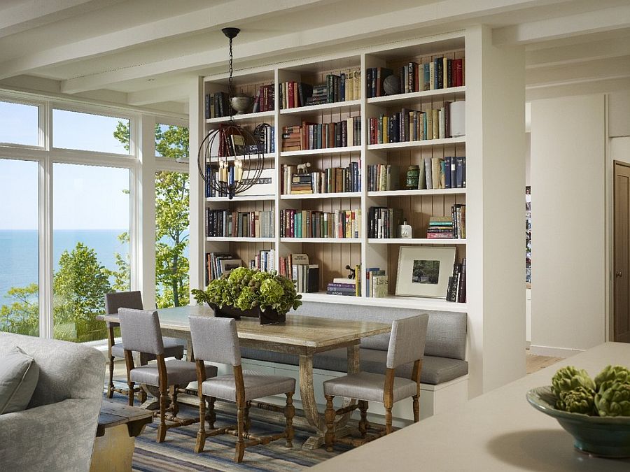 Wall of books also helps delineate space inside this contemporary home