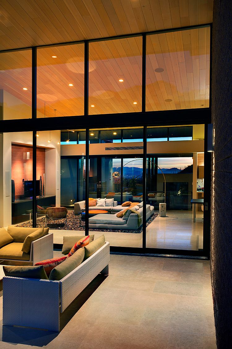 Wall of glass visually connects the living area with the patio