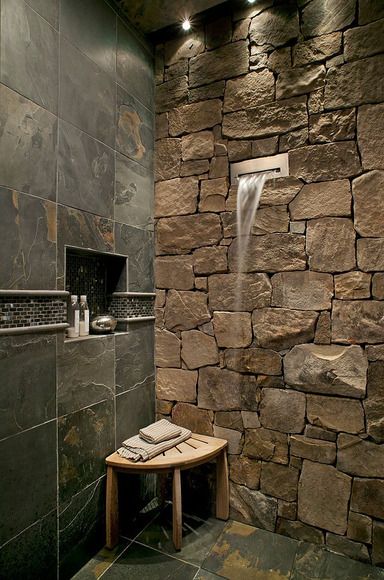 Waterfall shower head is a perfect fit for the fabulous stone wall in the bathroom [Design: Tyner Construction]