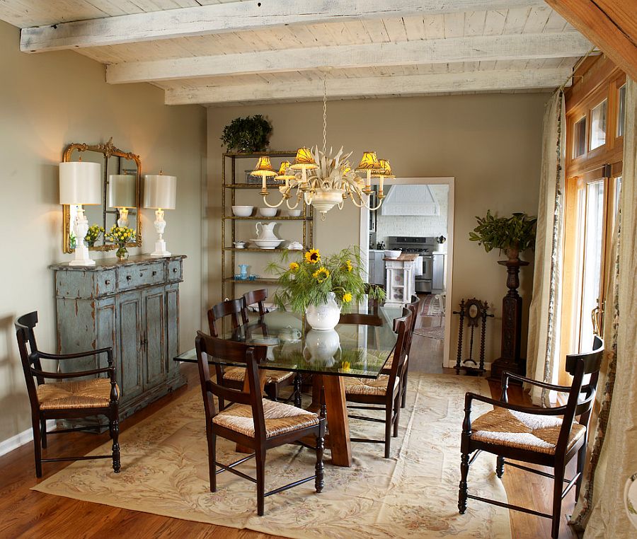 Weathered buffet and antique mirror give the cozy dining room a shabby chic look