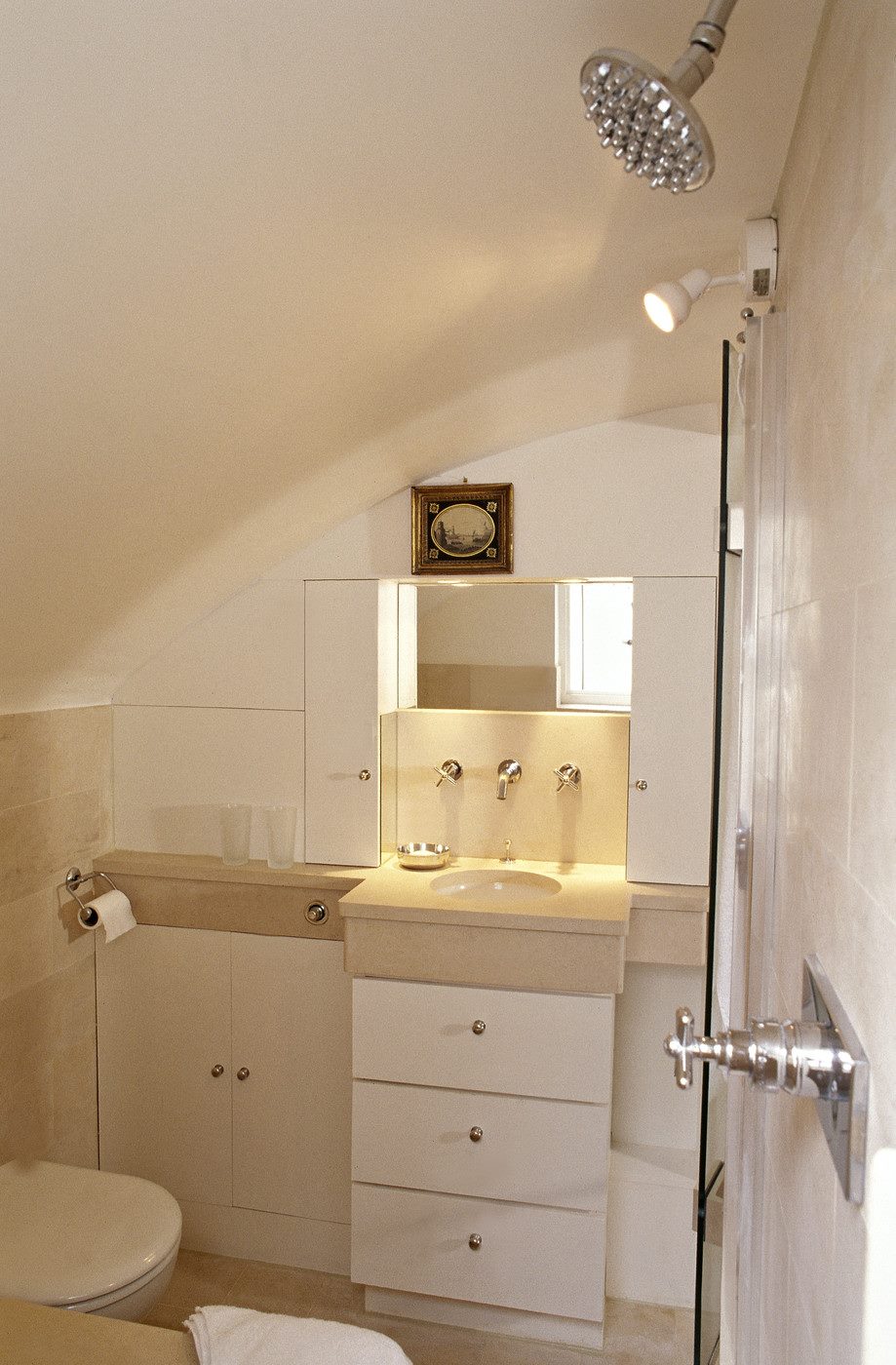 White bathroom with a wall-mounted spotlight