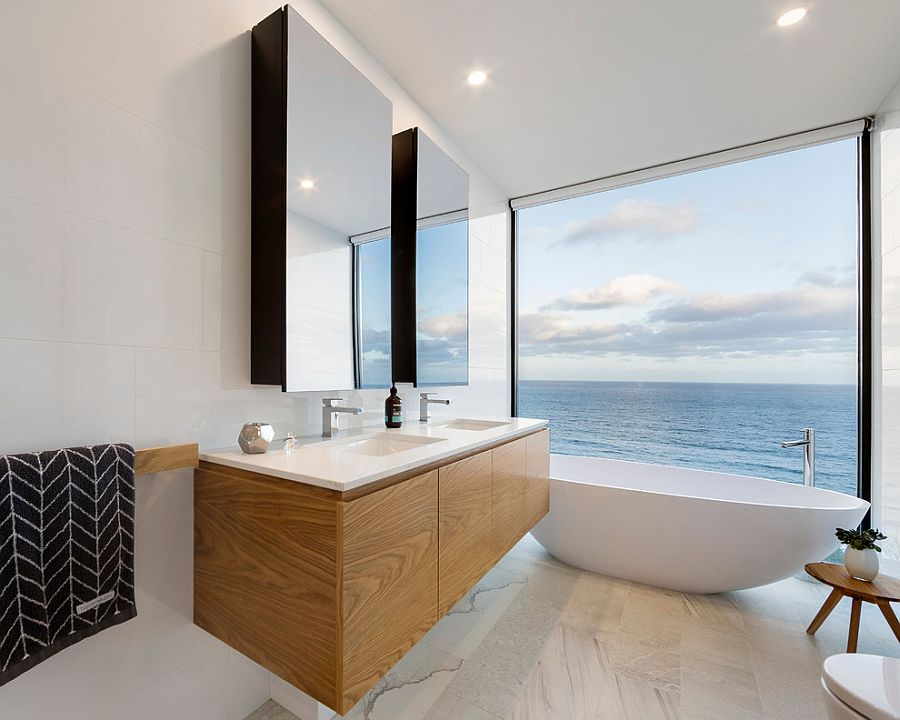 Wooden vanity adds warmth and contrast to the lovely contemporary bathroom