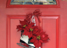 A-pair-of-skates-with-some-festive-poinsettias-hangs-on-a-red-door-217x155