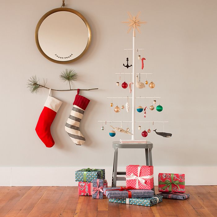 A small tree branch used as a Christmas stocking holder