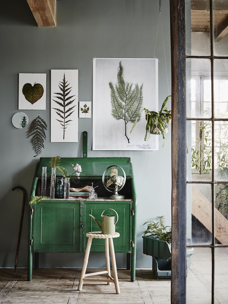 Beautiful nature-inspired wall art above a bright green desk