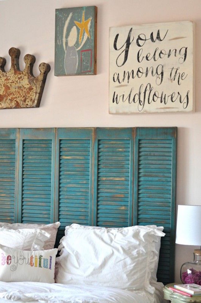 Beautiful turquoise shutters repurposed as a headboard