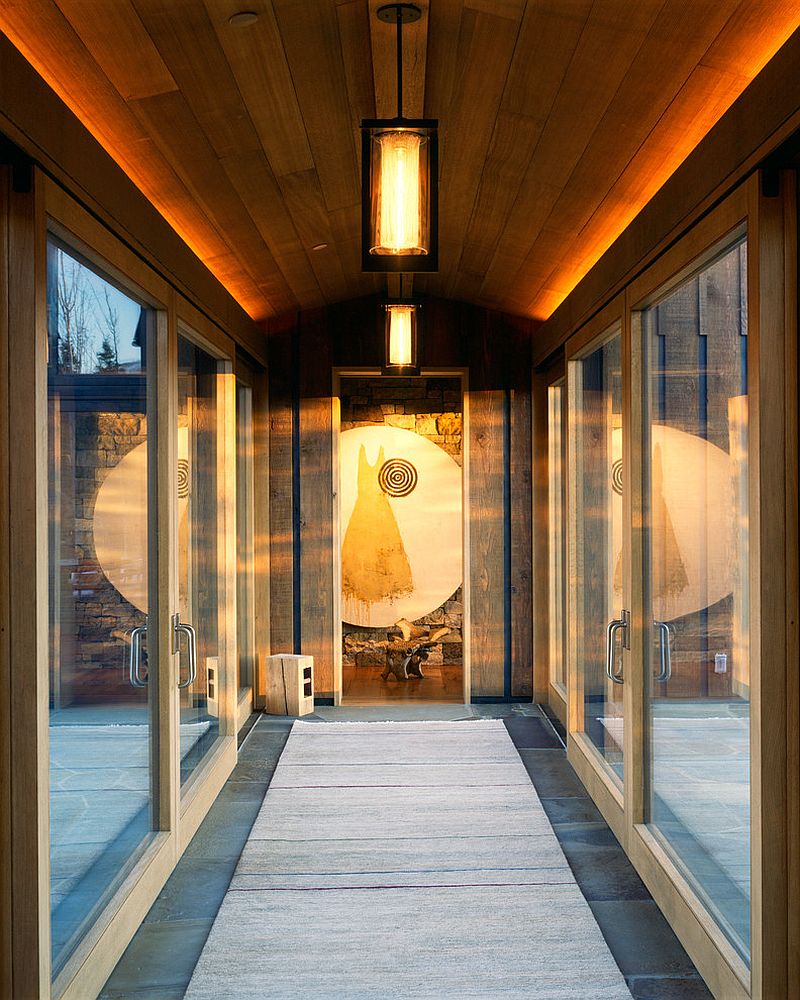 Brilliant lanter-style lighting coupled with LED strip lighting for the hallway with glass doors