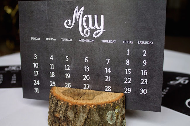 Chalkboard-style calendar printout with tree trunk holder