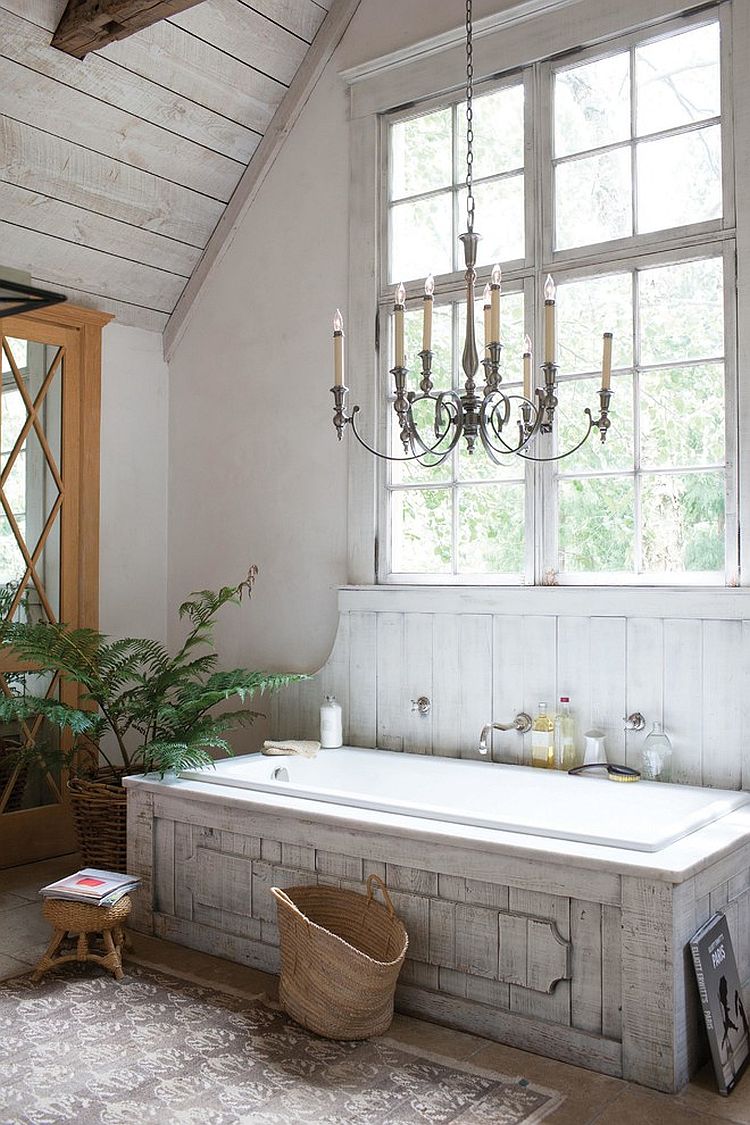 Classic chandelier, unique bathtub and farmhouse charm shape a relaxing bathroom