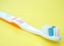 Clean-your-grout-with-a-toothbrush-217x155