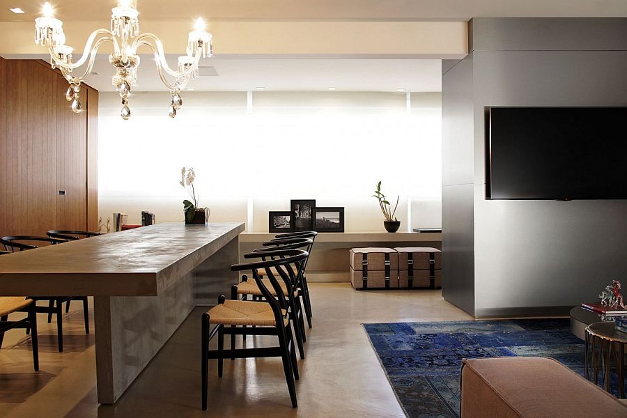 Concrete slab couple with wishbone chairs makes for a stunning dining space