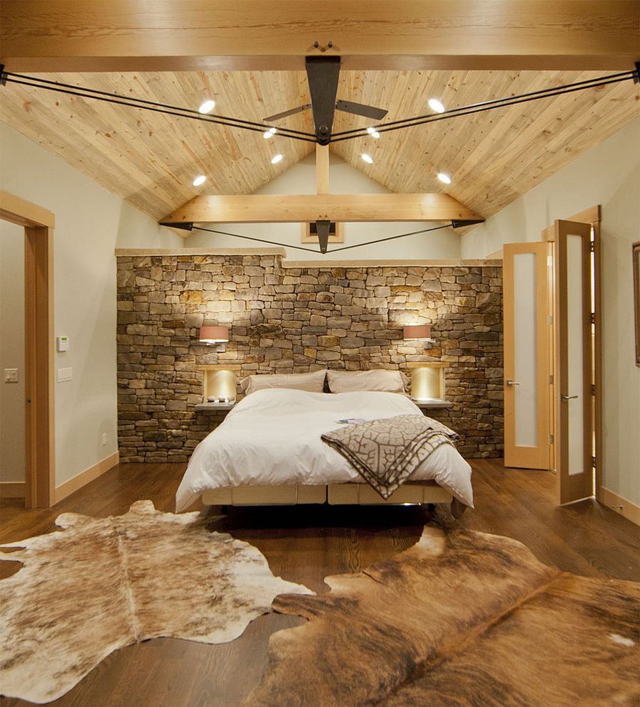 Contemporary bedroom with Montana limestone headboard wall and a wooden ceiling [Design: Kelly & Stone Architects]