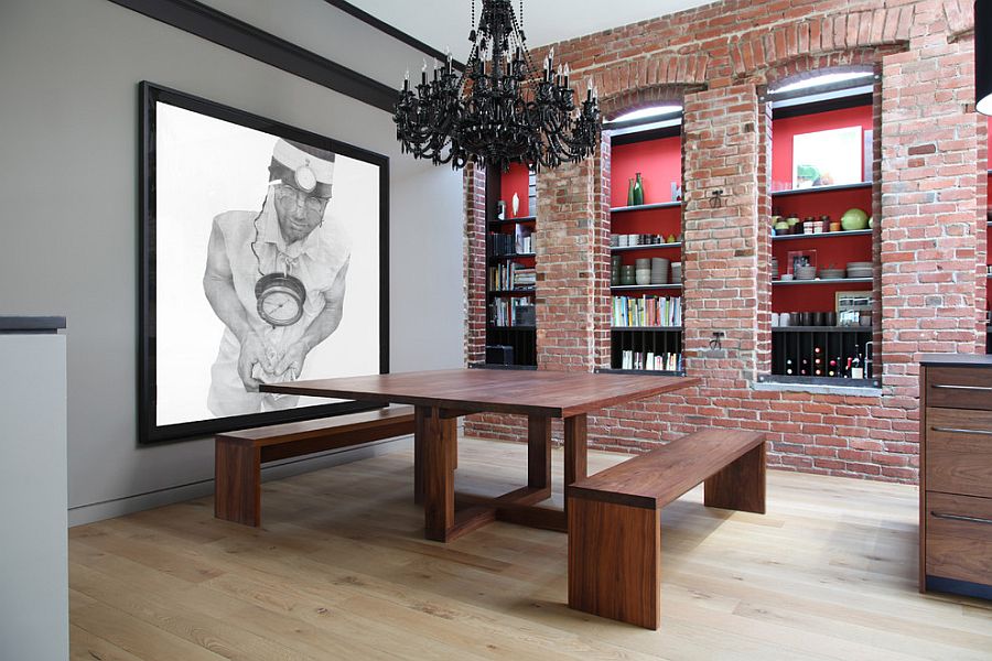 Contemporary dining room with a brick wall that features two different types of bricks