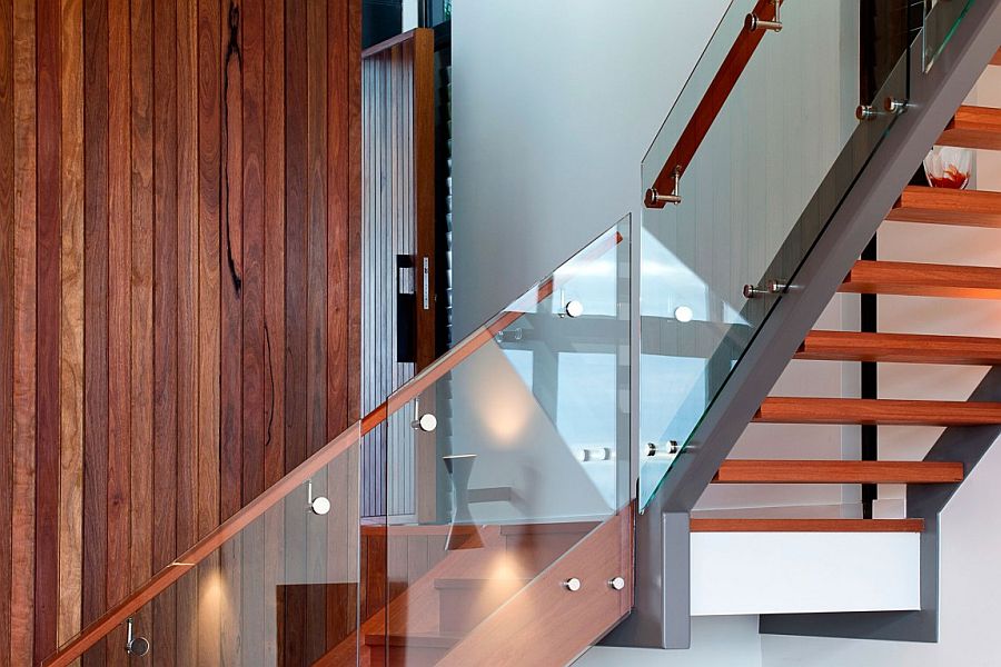 Contemporay wooden staircase with glass railing