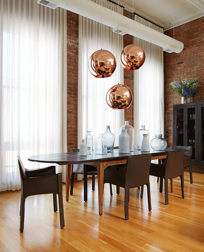 Copper pendant lights from Tom Dixon make a big visual statement in this dining room [Design: Jessica Lagrange Interiors]