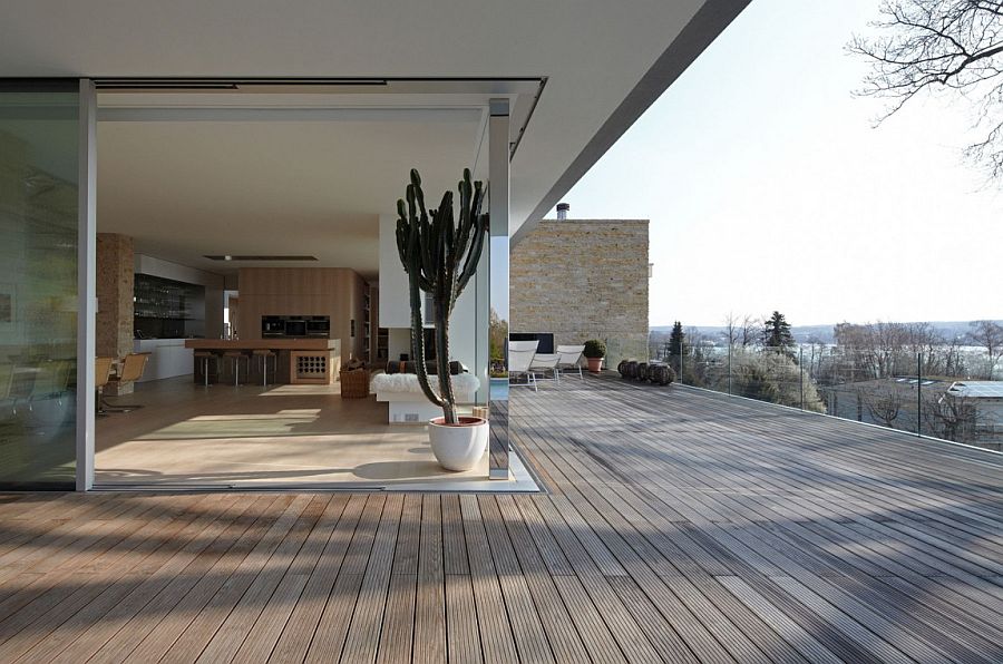 Corner sliding glass doors open up the kitchen and dining space to the view outside