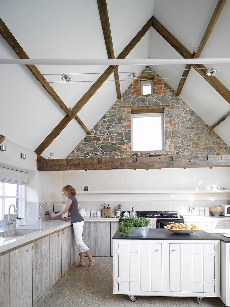 Creative use of the stone wall in the contemporary white kitchen