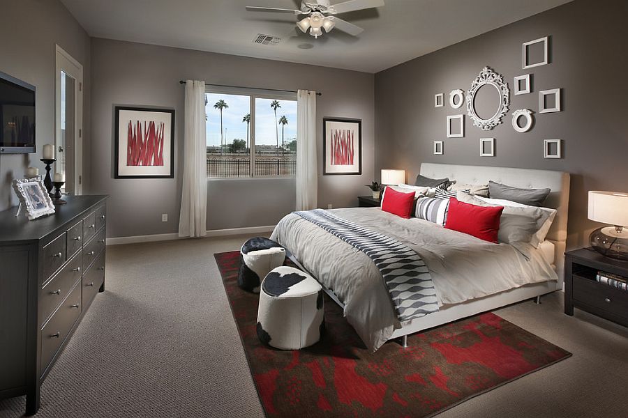 Curated collection of empty frames on the wall brings class to the contemporary bedroom in gray