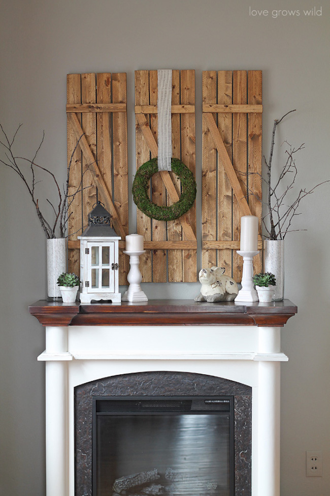 DIY barn wood shutters over a fireplace mantel