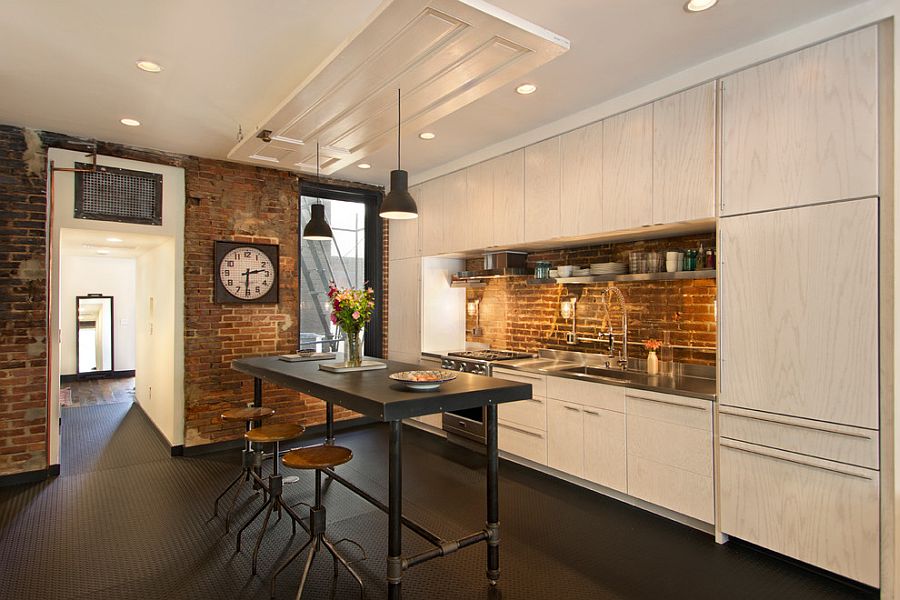 Dark flooring anchors the industrial kitchen with smart brick walls [Design: Bennett Frank McCarthy Architects]