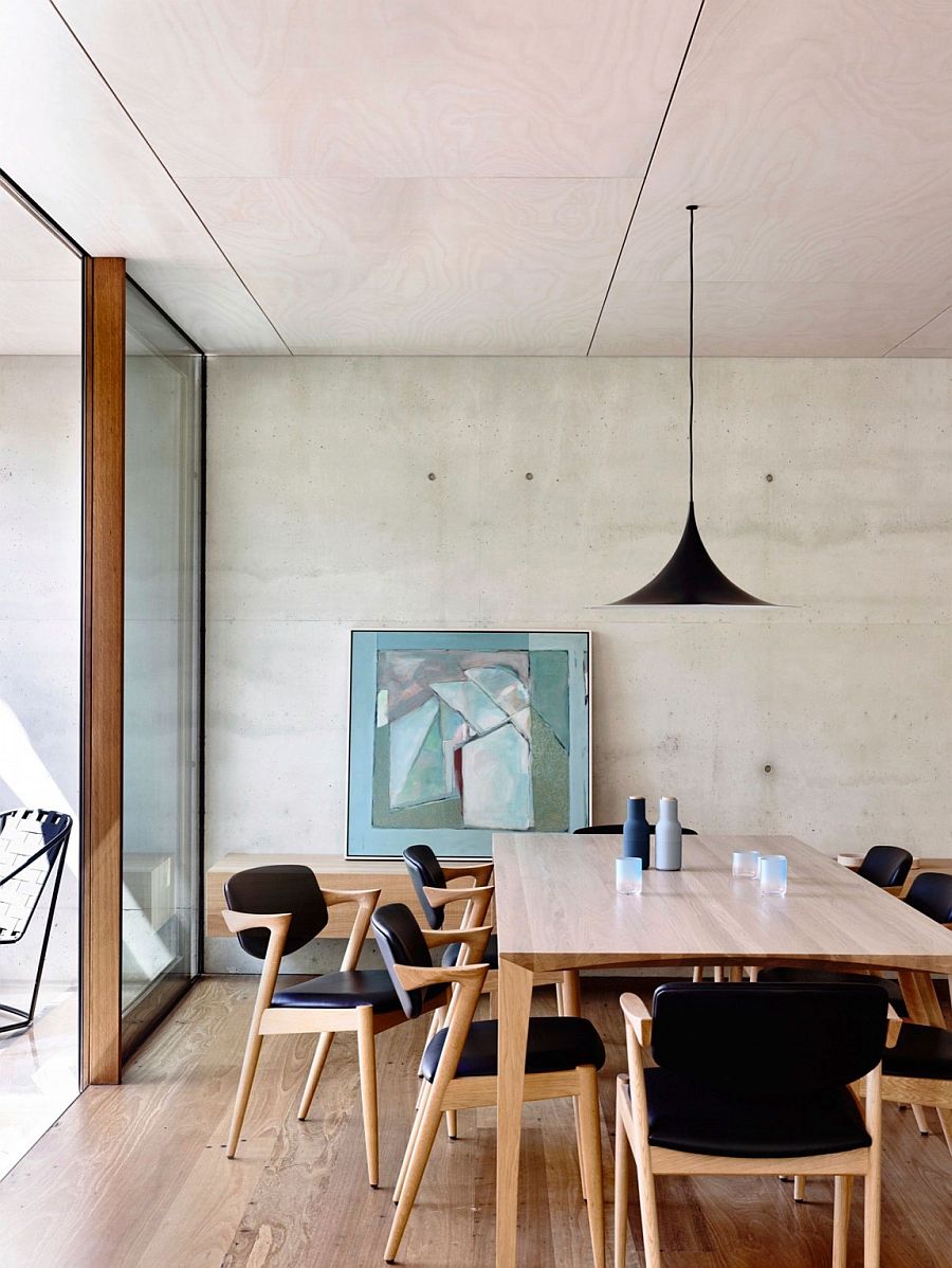 Dining room with a hint of black and concrete walls