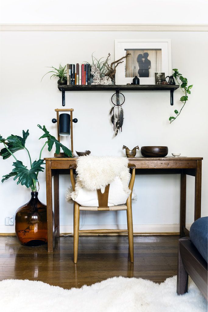 Eclectic office space with wood furniture and touches of greenery