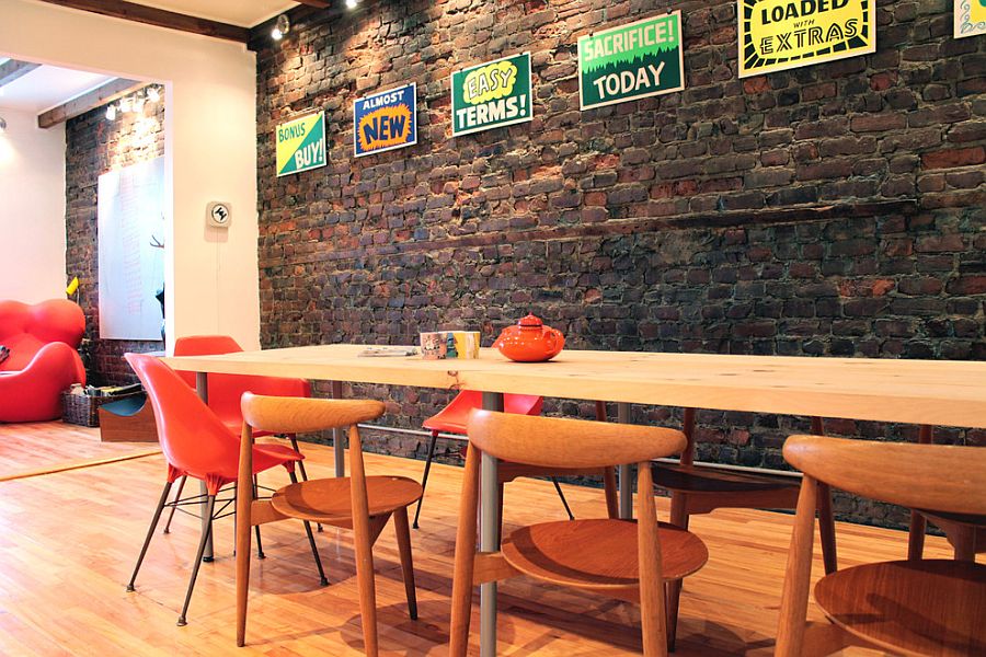 Eclectically vintage dining room with brick wall and a splash of color [Design: Laura Garner]