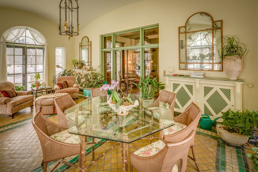 Exquisite Mediterranean sunroom with a dash of rose and green