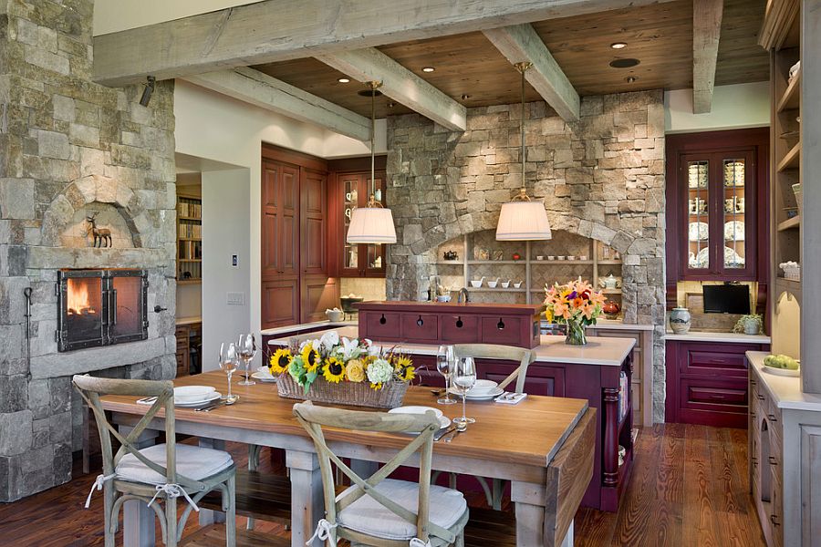 Exquisite eat-in kitchen with fireplace, purple cabinets and stone walls