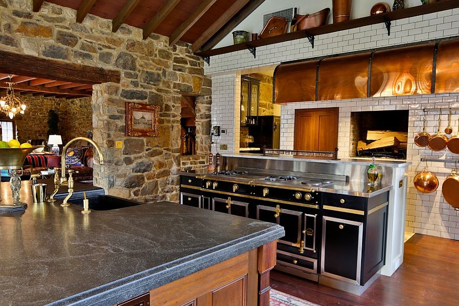 Farmhouse style kitchen with stone wall and La Cornue Range [Design: Squaresapace]