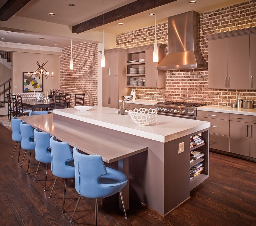 Gorgeous gray cabinets and kitchen island in kitchen with beautiful brick wall [Design: Jamestown Estate Homes]