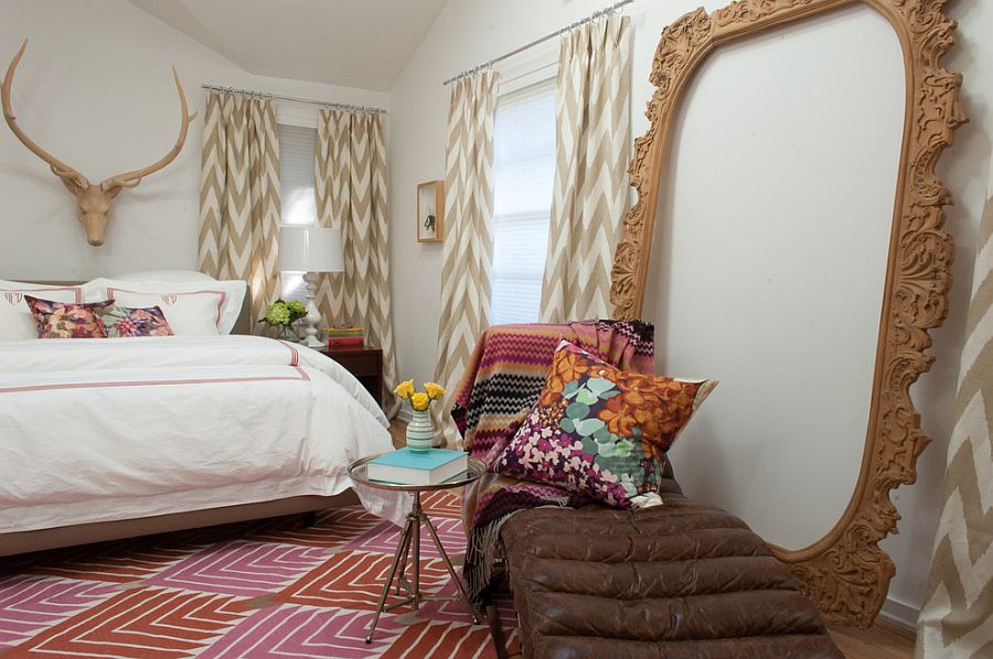 Hand-carved wooden frame adds visual height to the eclectic bedroom [Design: Angela Flournoy]