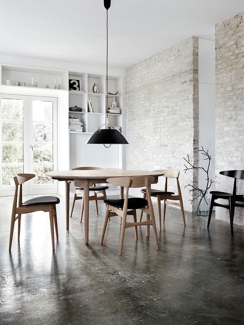 Industrial dining room with a fabulous finish for the exposed brick wall [Design: SUITE New York]