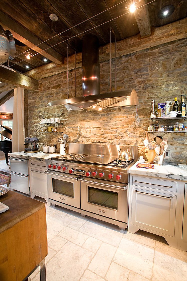 Ingenious industrial kitchen with stone wall and marble countertops