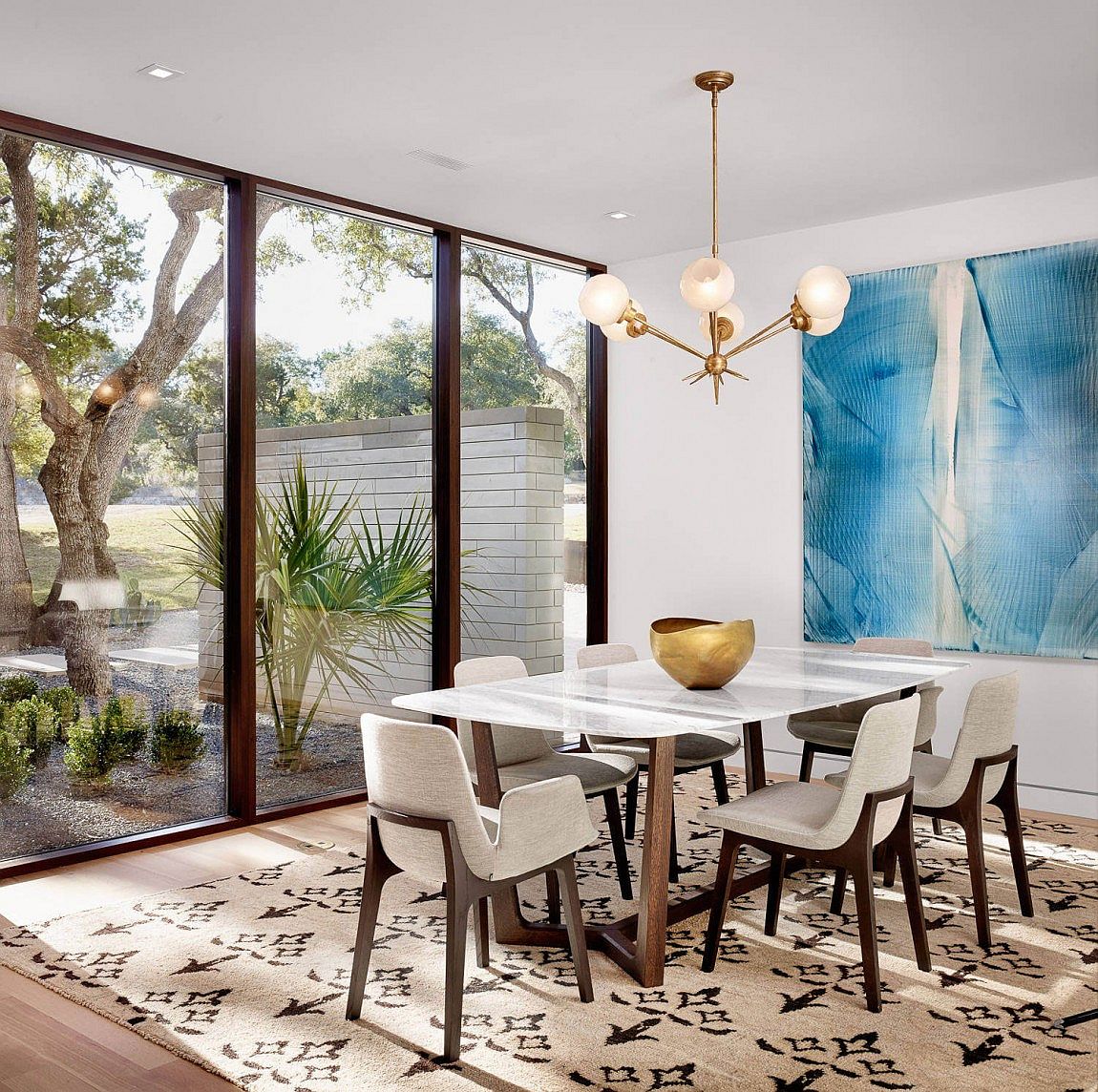 Large glass windows open up the contemporary dining room to the view outside