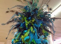 Large-peacock-inspired-tree-topper-with-lots-of-blue-and-green-ribbon-217x155