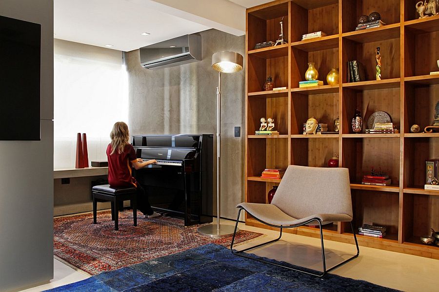 Large wooden shelf in the living area and a piano in the corner