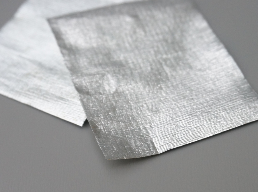 Layer your two pieces of paper or ribbon