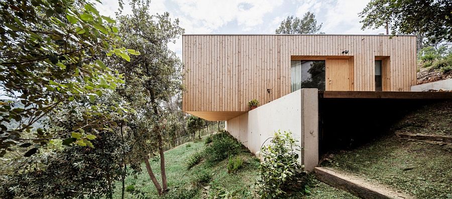 Lightweight wooden contruction on retaining walls creates a home with minimal footprint